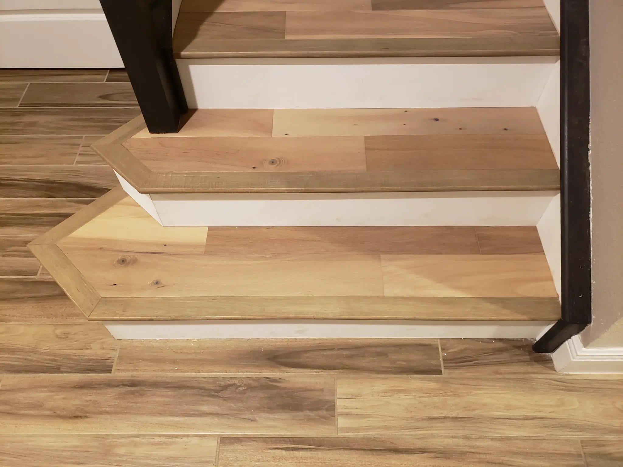 Angled bottom step with wood-look nosing wrapped around its corners